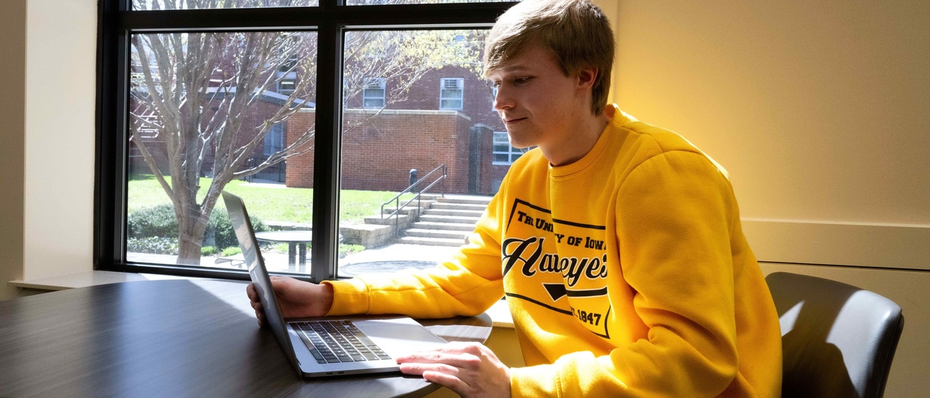 student smiling with laptop