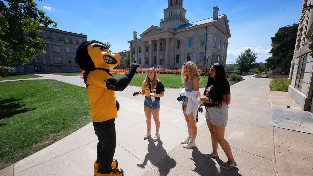 Herky and students on the pentacrest